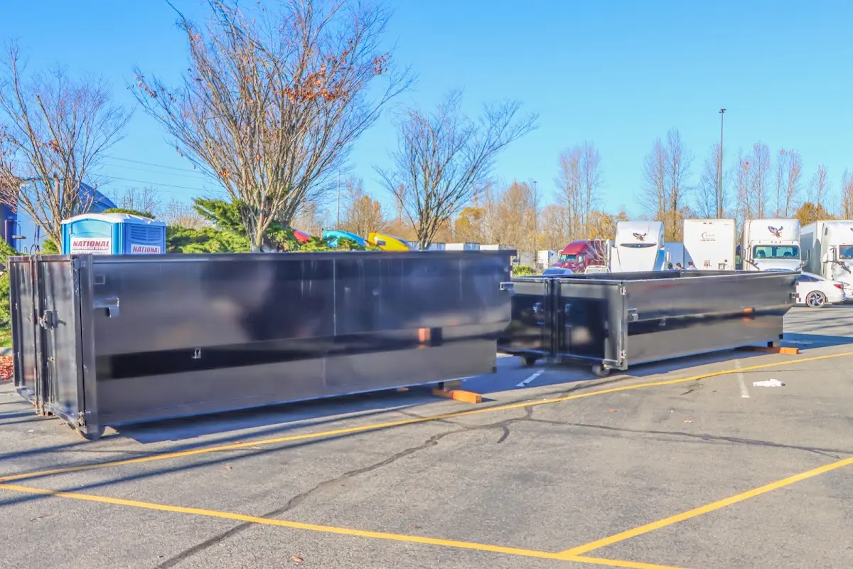 Professional dumpster rental service with roll-off container on residential driveway in Alcoa